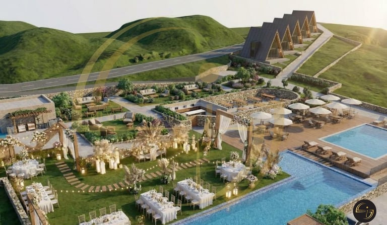 Aerial view of a luxury resort complex with blue pools, white buildings, and green rolling hills surrounding the property